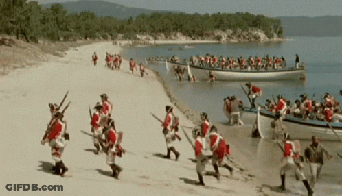 Men In Red And White Running On Beach GIF