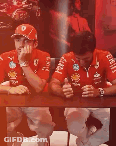 Men In Red Ferrari Shirts Sitting At Table GIF