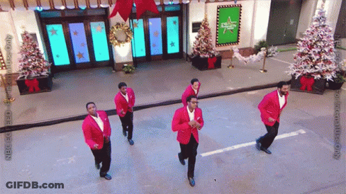 Men In Red Jackets Dancing In Front Of Abc Building GIF
