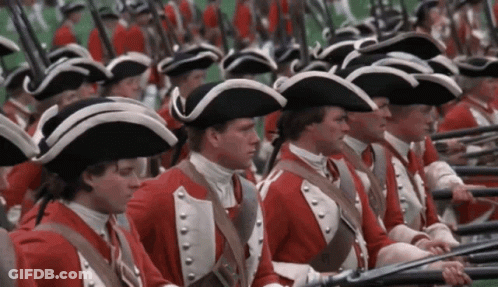 Men In Red Uniforms And Hats Holding Guns GIF