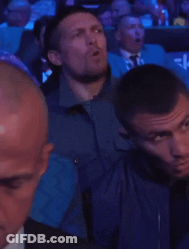Men In Stadium With Blue Seat Saying Sky GIF