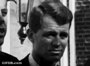 Men In Suit Standing Outside Brick Building GIF