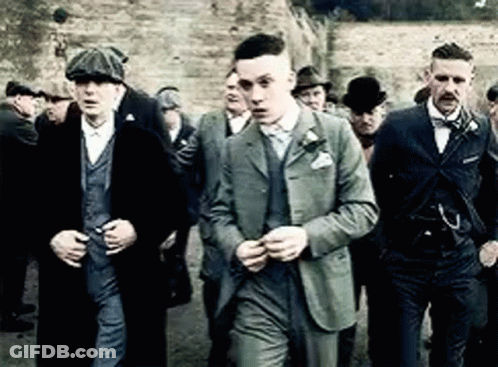 Men In Suits And Hats Standing Together GIF