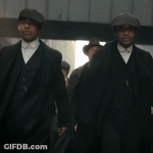 Men In Suits And Hats Walking Down Street GIF