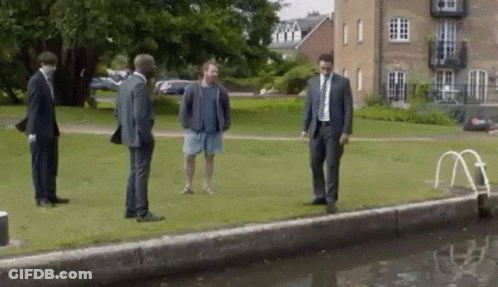 Men In Suits And Shorts By Water GIF