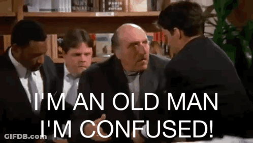 Men In Suits And Ties Talking At Table GIF