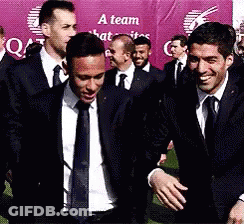 Men In Suits And Ties With A Team Sign GIF