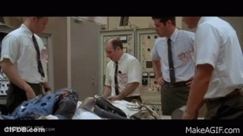 Men In Suits Around Table With Robot GIF