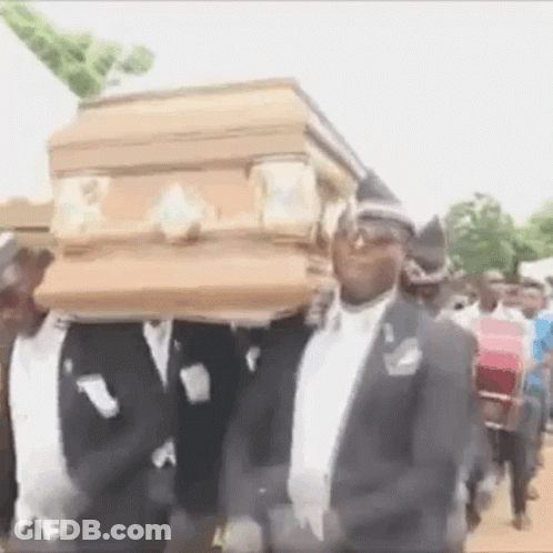 Men In Suits Carrying Coffin On Heads GIF