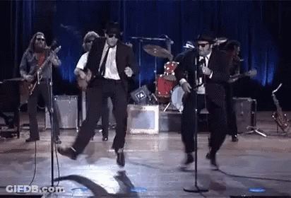 Men In Suits Dancing On Stage GIF