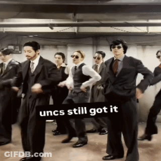 Men In Suits Dancing Under Uncs Still Got It Sign GIF