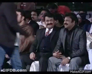 Men In Suits Laughing In Stadium GIF