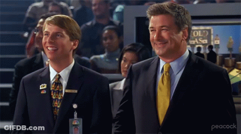 Men In Suits Smiling In Front Of NASA Sign GIF