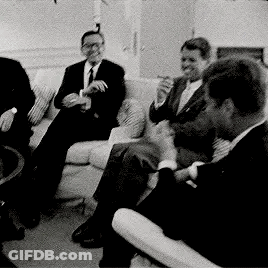 Men In Suits Smoking On Couch GIF