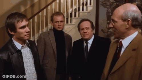 Men In Suits Standing In Front Of Staircase GIF