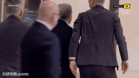 Men In Suits Walking Past Directe Z Sign GIF