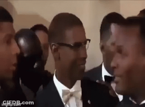 Men In Tuxedos And Bow Ties Standing Together GIF