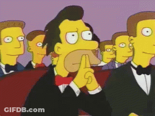 Men In Tuxedos And Bow Ties Watching Cartoon GIF