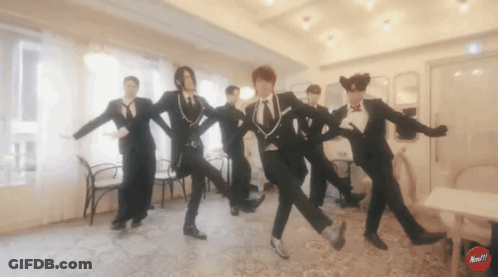 Men In Tuxedos Dancing With Red Next Button GIF