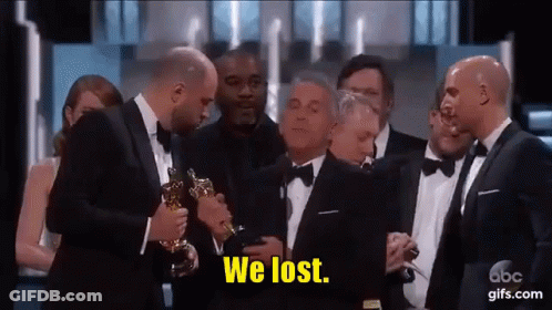 Men In Tuxedos Holding Oscar Trophy Saying We Lost GIF