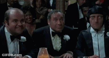 Men In Tuxedos Sitting At Casino Table GIF