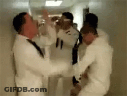 Men In White Suits Standing In Hallway GIF
