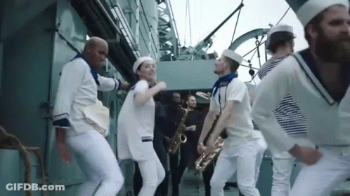Men In White Suits Standing In Hallway GIF