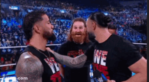 Men In Wrestling Ring One Wearing We Shirt GIF