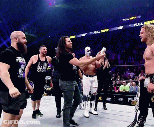 Men In Wrestling Ring With Join Dark Order Shirt GIF