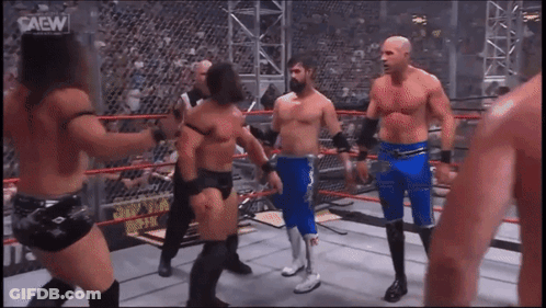 Men In Wrestling Ring With Saew GIF