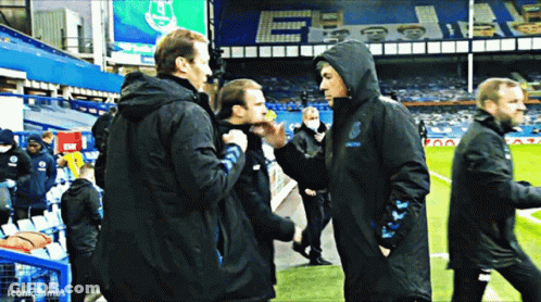 Men On Soccer Field One With Hood GIF