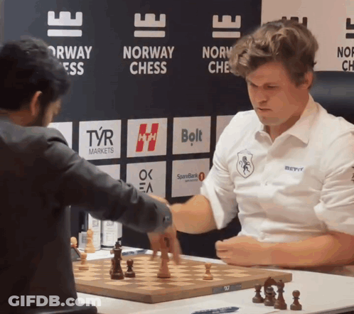 Men Playing Chess In Front Of Norway Sign GIF