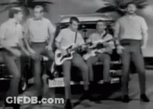 Men Playing Guitars In Front Of Car With NC License Plate GIF