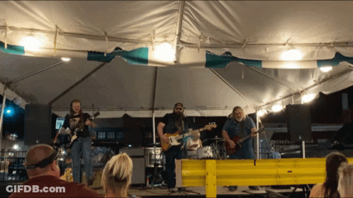 Men Playing Guitars Under Breakfast Inn Tent GIF