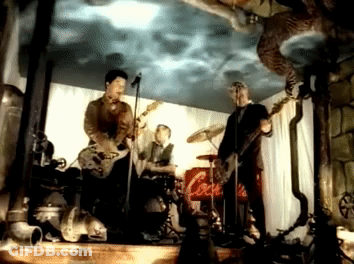Men Playing Instruments On Stage With Coca Cola Sign GIF