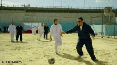 Men Playing Soccer In Sand GIF