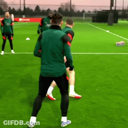 Men Playing Soccer, One In Green Nike Jacket GIF
