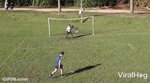 Men Playing Soccer With Goal GIF