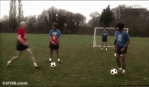 Men Playing Soccer With Goal GIF