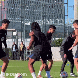 Men Playing Soccer With Stadium Sign GIF