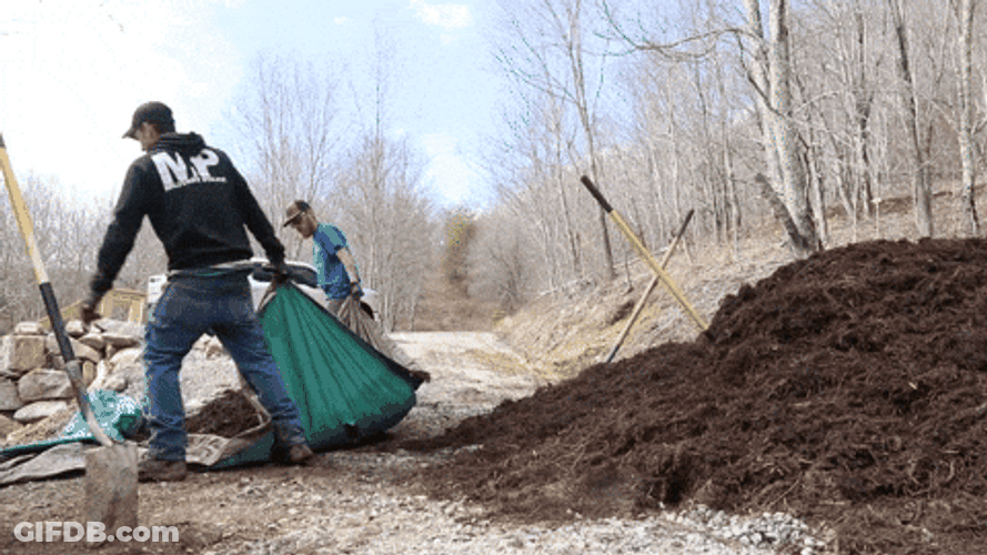 Men Pulling Tarp Containg Mulch GIF