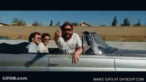 Men Riding Silver Convertible Giving Middle Finger GIF