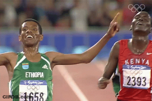 Men Running In Green Ethiopia And Red Kenya Shirts GIF