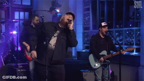 Men Singing And Playing Guitar On Stage GIF