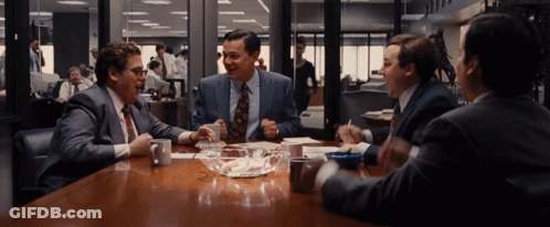 Men Sitting Around Table With Bowl Of Ashes GIF