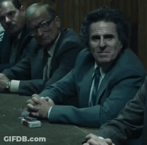 Men Sitting Around Table With Cigarettes GIF