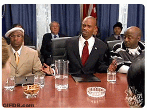 Men Sitting Around Table With Water Pitcher And Ashtray GIF