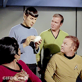 Men Sitting Around Table With White Object GIF