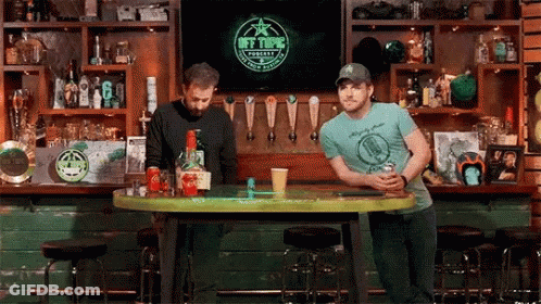 Men Sitting At Bar Watching TV GIF