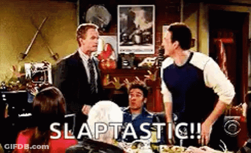 Men Sitting At Table With Slaptastic Sign GIF